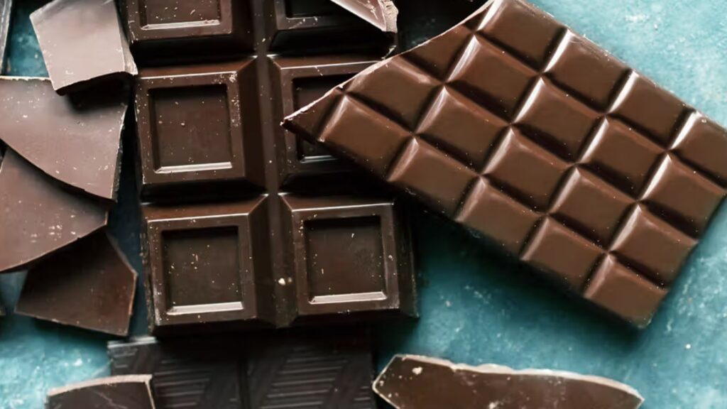Dark chocolate squares on wooden board, brain-boosting snack