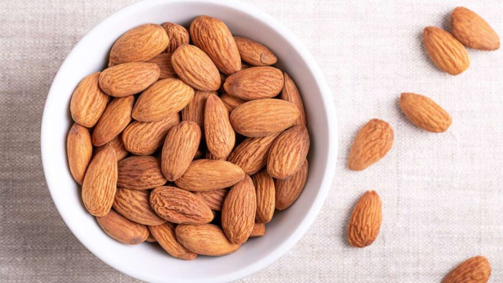 Handful of almonds in a bowl, healthy snack for focus