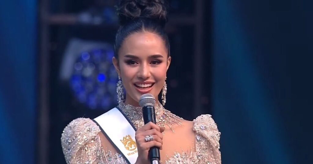 Elegant woman speaking at event.