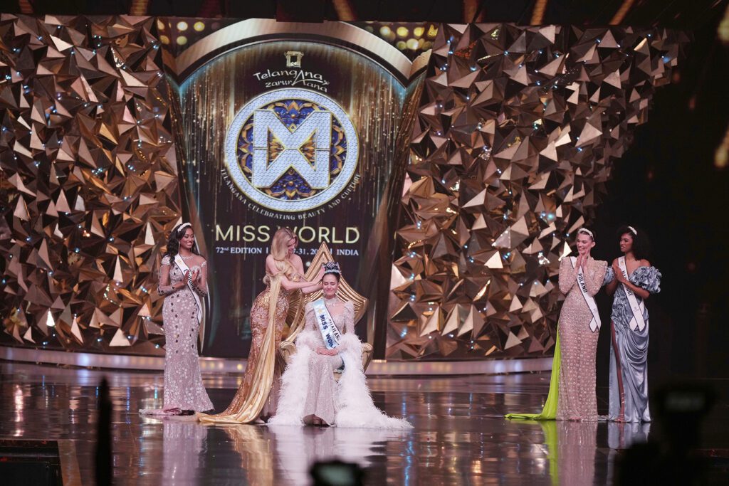 Beauty pageant winner crowned on stage.