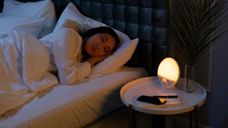A woman sleeping peacefully in a cozy bedroom, representing micro habits that improve sleep naturally.