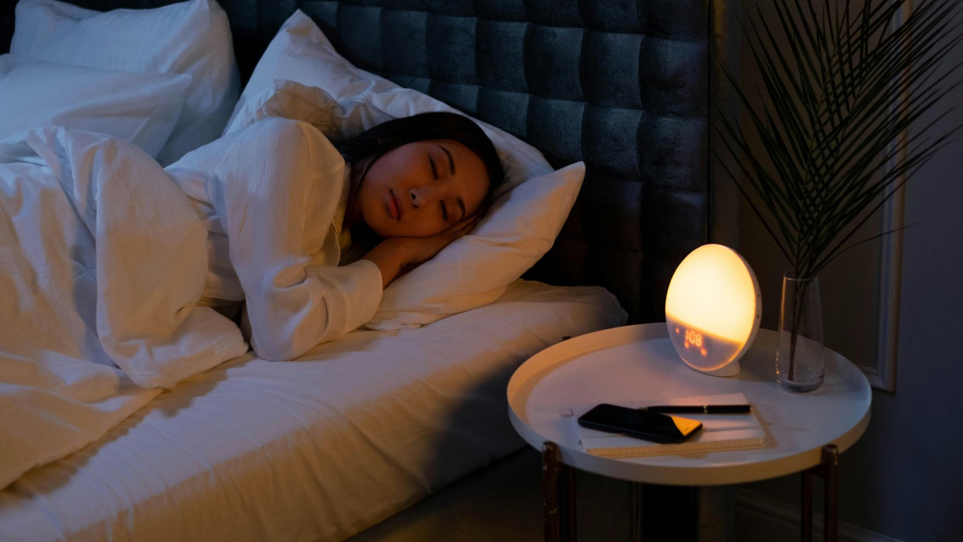 A woman sleeping peacefully in a cozy bedroom, representing micro habits that improve sleep naturally.
