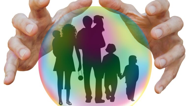 Family protected inside two large caring hands, symbolizing term insurance vs health insurance coverage